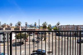Los Angeles apartment for rent - a balcony with a black railing and a city in the background