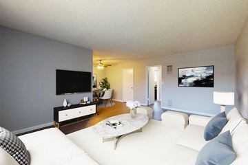 Los Angeles apartment for rent - A living room with a white couch and a flat screen TV mounted on the wall.
