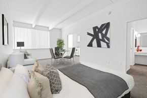 Van Nuys apartment for rent - A bedroom with a large bed and a chair.