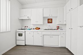 Van Nuys apartment for rent - A white kitchen with a fridge, oven, and sink.