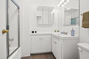 Van Nuys apartment for rent - A white bathroom with a towel hanging on the towel rack.