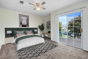 Redlands apartment for rent - A bedroom with a large bed and a ceiling fan.
