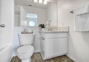 Redlands apartment for rent - a bathroom with a toilet and a sink and a mirror