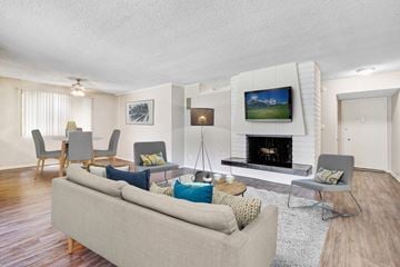Sherman Oaks apartment for rent - A living room with a grey couch and a fireplace.