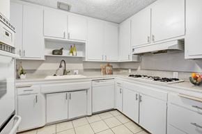 Sherman Oaks apartment for rent - A white kitchen with a stove top oven and a microwave.