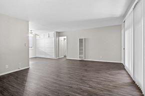 Beverly Hills apartment for rent - A spacious room with wooden flooring and white walls.