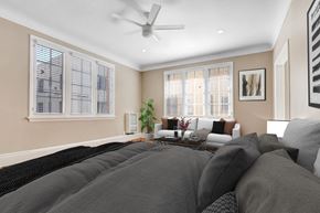 Los Angeles apartment for rent - a bedroom with a large bed and a couch and a ceiling fan