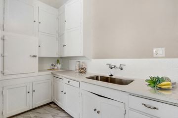 Los Angeles apartment for rent - A white kitchen with a sink and a counter.