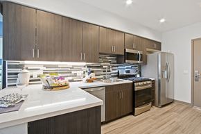 Los Angeles apartment for rent - A modern kitchen with wooden cabinets and stainless steel appliances.