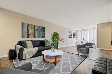 Los Angeles apartment for rent - A living room with a grey couch and a painting on the wall.