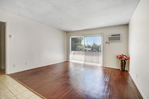 Panorama City apartment for rent - A room with a wooden floor and a sliding glass door.