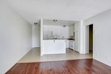 Panorama City apartment for rent - A kitchen with white cabinets and a white island.
