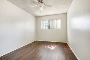 Panorama City apartment for rent - A room with a ceiling fan and a window with blinds.
