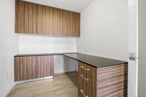 Los Angeles apartment for rent - A kitchen with wooden cabinets and a black counter.