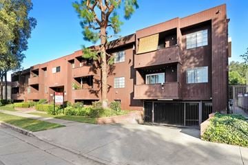 Studio City apartment for rent - A brown building with a tree in front of it.