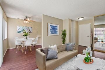 Torrance apartment for rent - A living room with a couch, a dining table, and a painting on the wall.