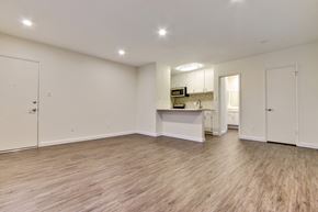 Van Nuys apartment for rent - A spacious room with wooden flooring and white walls.