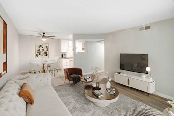 Winnetka apartment for rent - A living room with a white couch and a television.