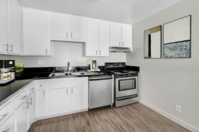 Winnetka apartment for rent - an empty kitchen with white cabinets and stainless steel appliances
