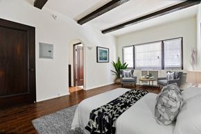 Beverly Hills apartment for rent - A bedroom with a large bed and a chair.
