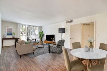 Sherman Oaks apartment for rent - A living room with a white table and chairs.