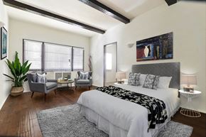 Beverly Hills apartment for rent - A bedroom with a large bed and a potted plant.