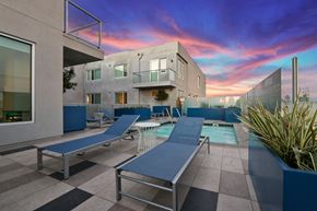 Los Angeles apartment for rent - A modern house with a pool and lounge chairs.