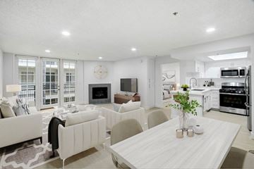 Los Angeles apartment for rent - A modern living room with a white couch and a dining table.