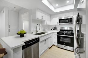 Los Angeles apartment for rent - a white kitchen with stainless steel appliances and white counter tops