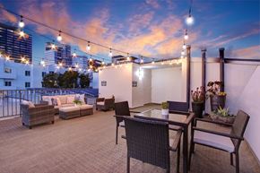 Los Angeles apartment for rent - A patio with a table, chairs, and string lights.