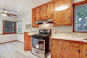 Valley Village apartment for rent - A kitchen with wooden cabinets and a stove top oven.