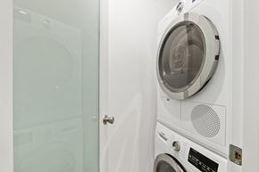Santa Monica apartment for rent - A white front loading washing machine with a transparent door.