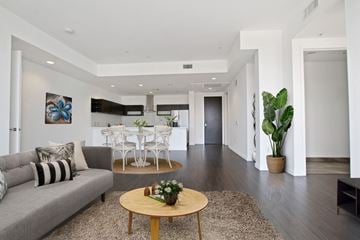 Culver City apartment for rent - A living room with a grey couch and a wooden coffee table.