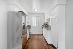 Van Nuys apartment for rent - a renovated kitchen with white cabinets and stainless steel appliances