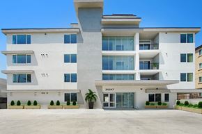 Winnetka apartment for rent - a large white apartment building with a large parking lot