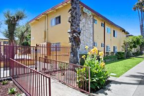 Westminster apartment for rent - A yellow building with a red gate in front.