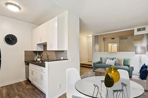Century City apartment for rent - A modern kitchen with white cabinets and a wooden countertop.