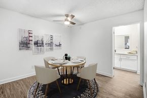 Tarzana apartment for rent - a dining room with a table and chairs and a ceiling fan