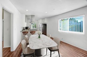 Sherman Oaks apartment for rent - a dining area with a table and chairs and a kitchen in the background