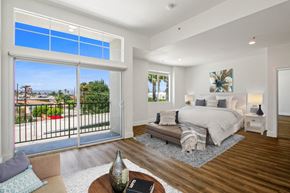 Los Angeles apartment for rent - A bedroom with a large bed and a view of the outside.