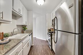 Los Angeles apartment for rent - A kitchen with a refrigerator, sink, and cabinets.