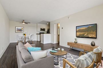 Los Angeles apartment for rent - A living room with a grey couch and a painting on the wall.