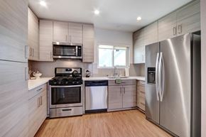 Burbank apartment for rent - A modern kitchen with stainless steel appliances and wooden cabinets.