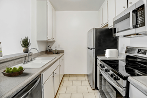 Reseda apartment for rent - an all white kitchen with stainless steel appliances and a sink