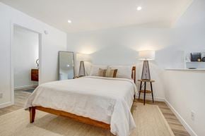 Los Angeles apartment for rent - Sleeping area with recessed lights, plank flooring, bathroom on the left