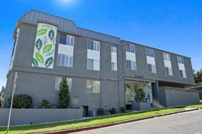 Studio City apartment for rent - A grey building with a banner of green leaves on it.