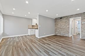Studio City apartment for rent - A room with wooden flooring and a stone wall.