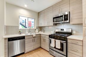 Burbank apartment for rent - A modern kitchen with wooden cabinets and stainless steel appliances.