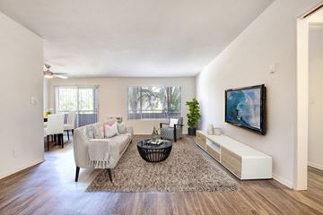 West Hollywood apartment for rent - A living room with a couch, a coffee table, and a painting on the wall.