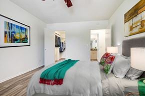 West Hollywood apartment for rent - a bedroom with white walls and a bed with a green blanket